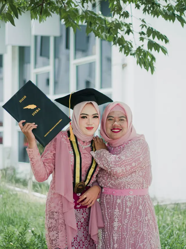 Wisudawati berkebaya merah muda bersama ibunya